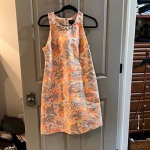 Sleeveless tunic dress with jewel neck and floral metallic pattern